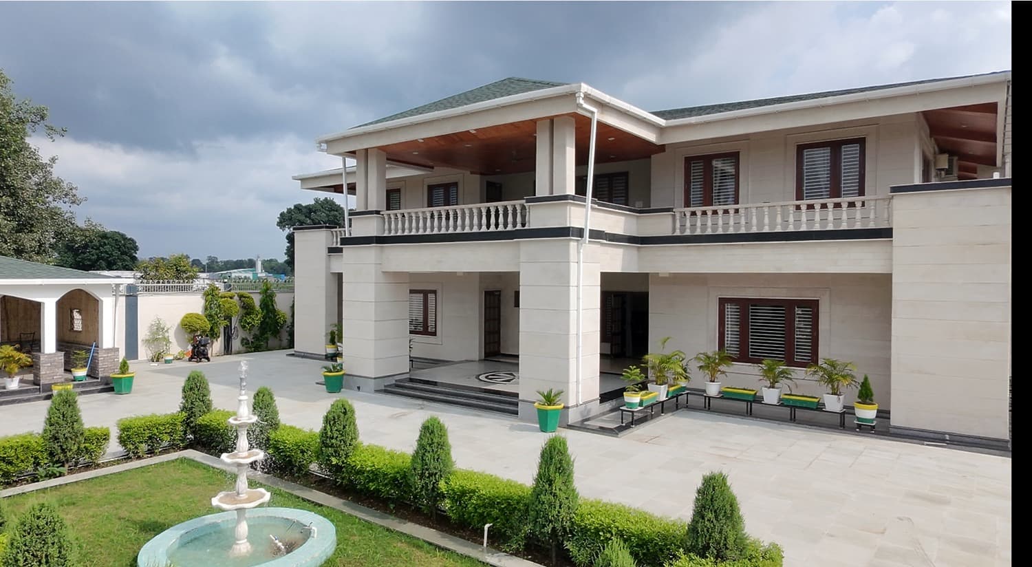 Luxury villa exterior with manicured hedges