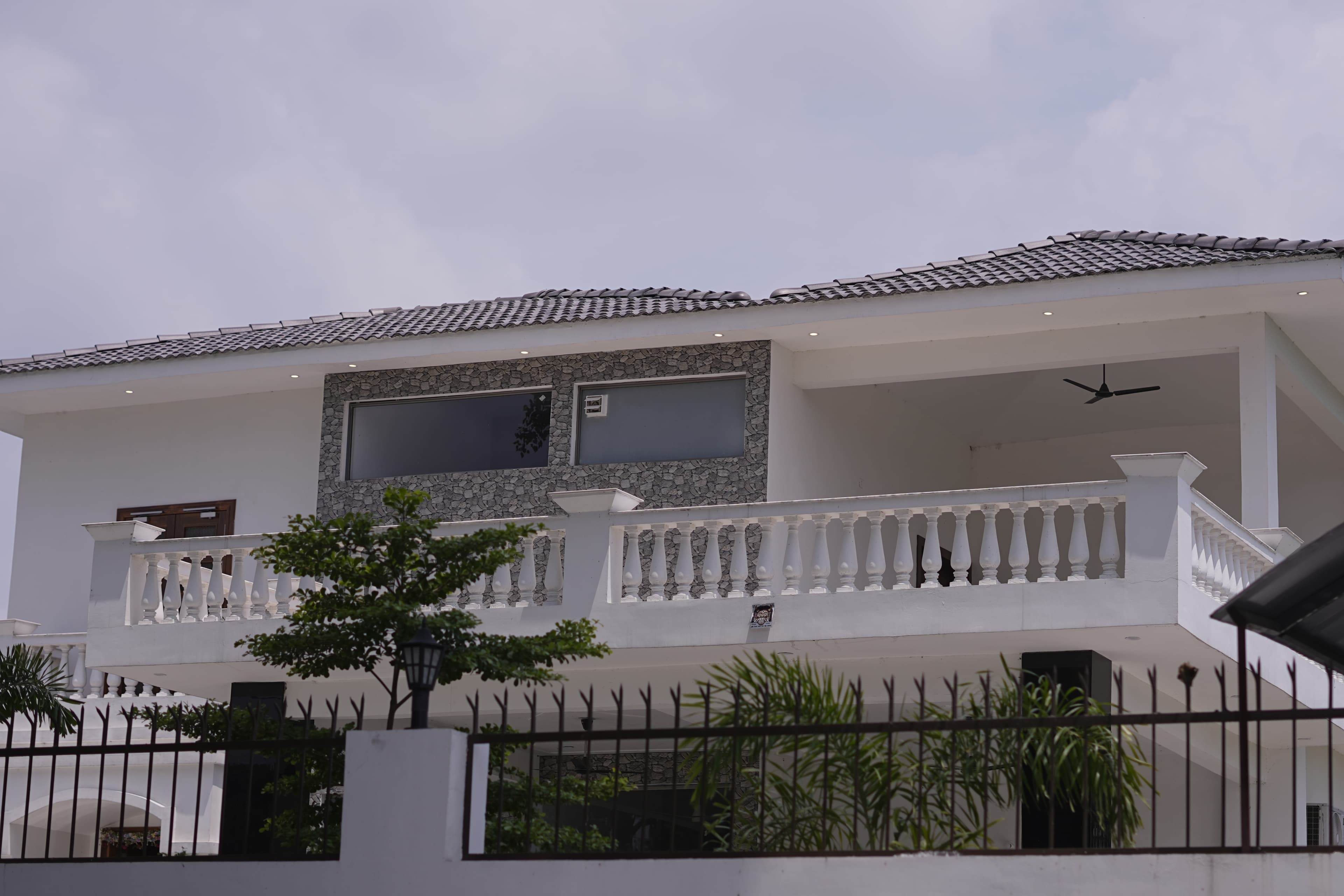 White villa with stone balcony and balustrades